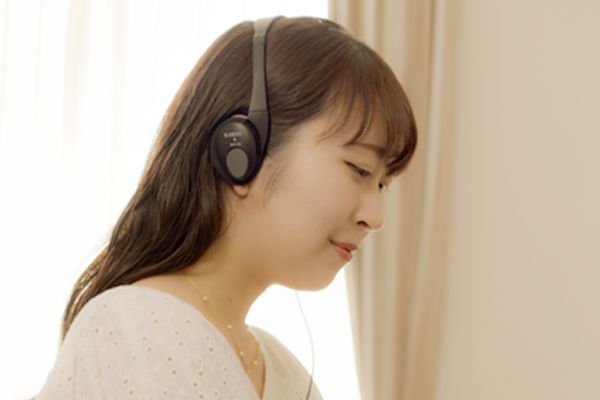 Woman Playing Piano in Living Room